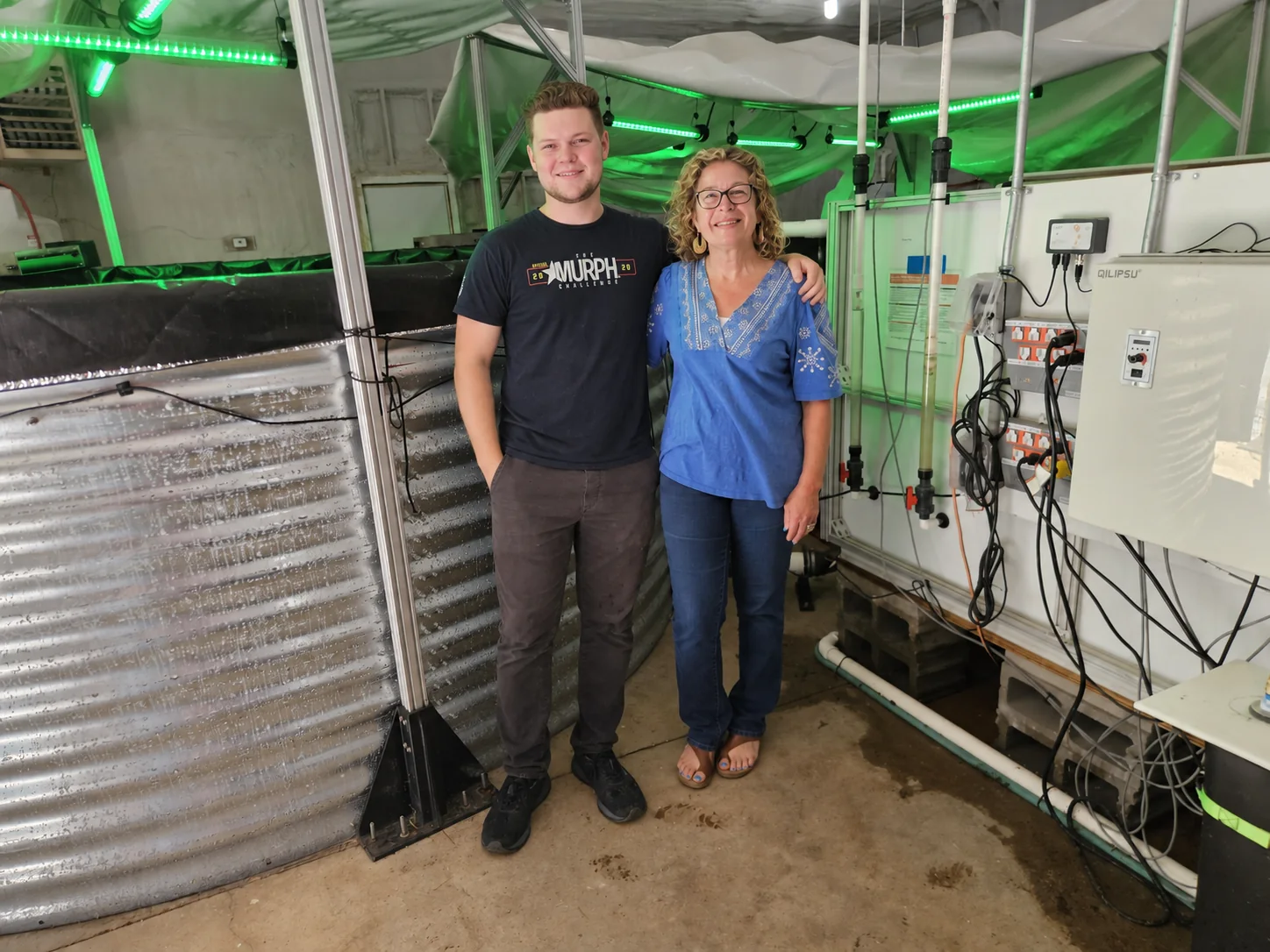 Tim Gregory and Jean Spencer standing together inside the PurBlu shrimp-growing facility.